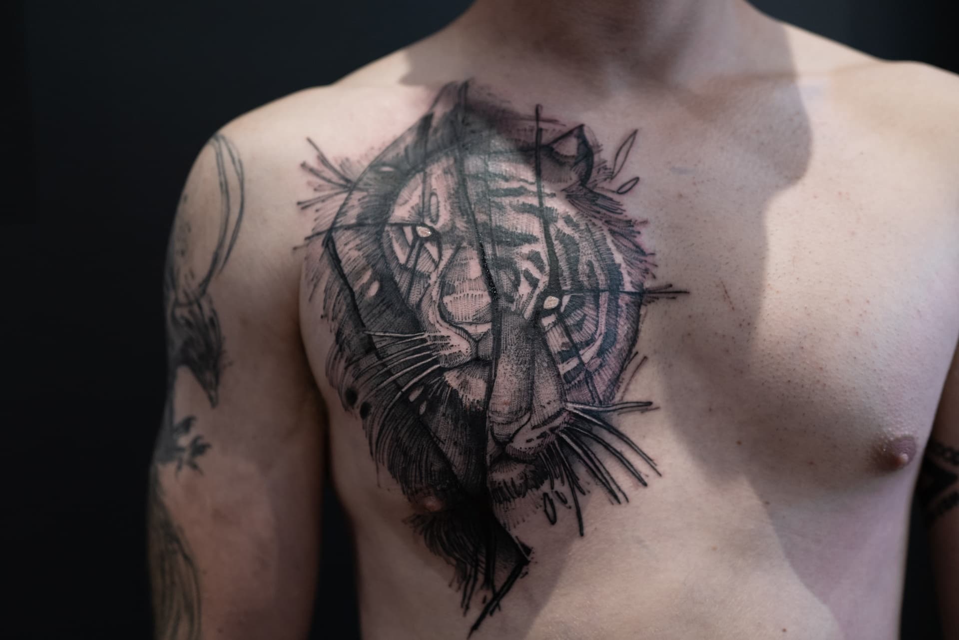 Abstract tiger tattoo on person's chest