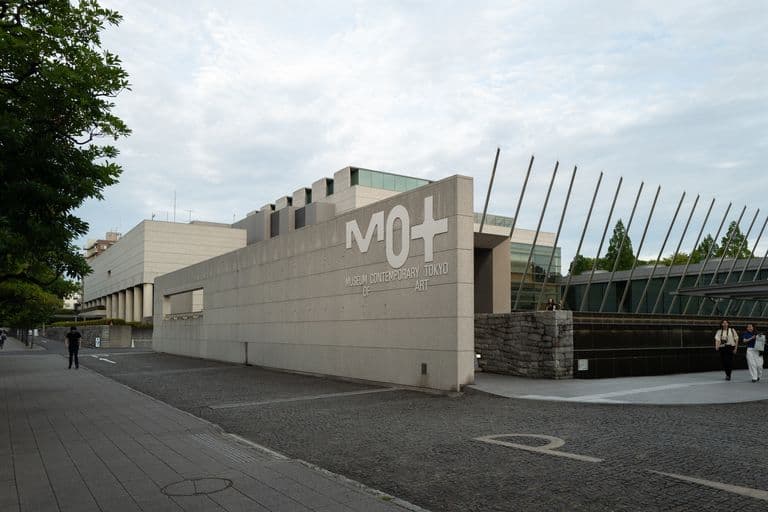 Exterior view of the Museum of Contemporary Tokyo of Art with a modern architectural design and large signage on the wall